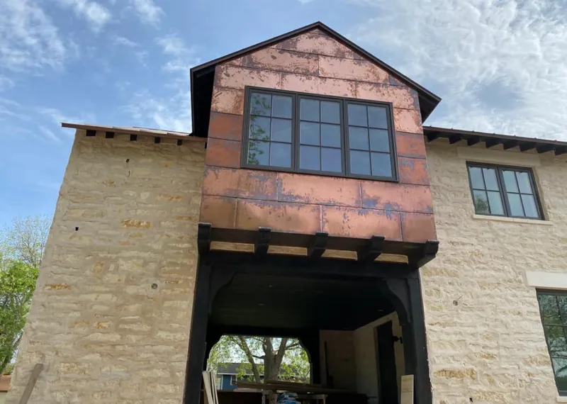 Copper metal panel facade on a stone building for Roof Repair in Carson